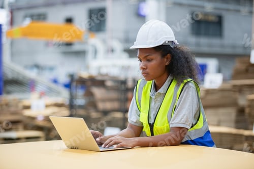Preview: Staff worker woman american african using laptop check quality and quantity stock paper product.8\