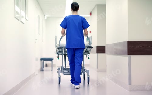 Preview: nurse carrying hospital gurney to emergency room