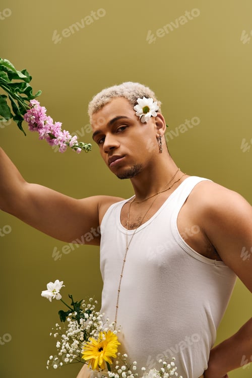 Preview: Young man showcasing floral beauty and modern fashion in a trendy studio setting