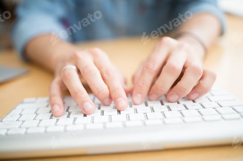 Preview: Close up of male designer typing on computer keyboard in printing press studio