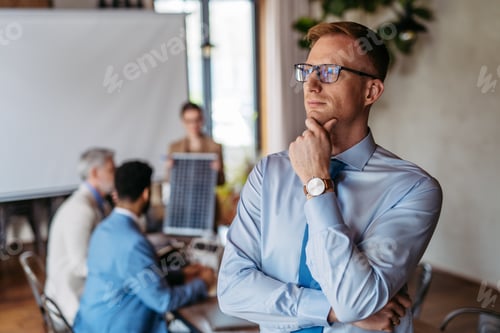 Preview: Portrait of confident young businessman during team meeting.