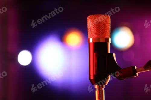 Preview: Microphone on stand against color background with blurred lights, space for text. Bokeh effect