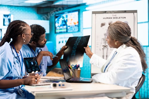 Preview: African American doctor discussing with her nurses to find treatment options