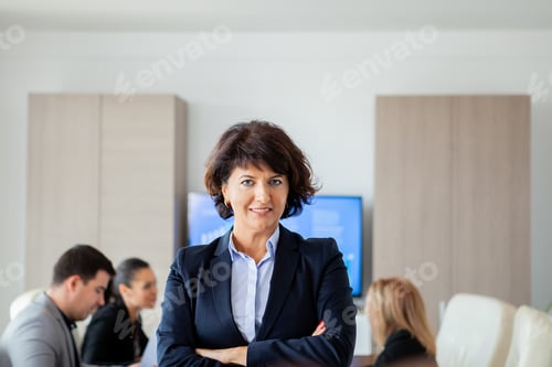 Preview: Middle aged business woman in conference room.