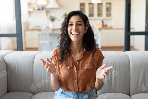 Preview: Headshot of happy young woman speaking to her friend on computer webcam