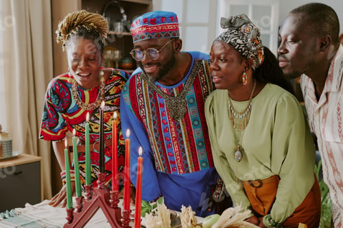 Preview: Group of Black Young Adults Celebrating Kwanzaa Lighting Kinara Candles Together