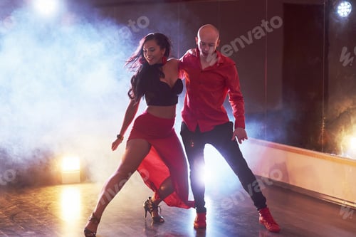 Preview: Skillful dancers performing in the dark room under the concert light and smoke