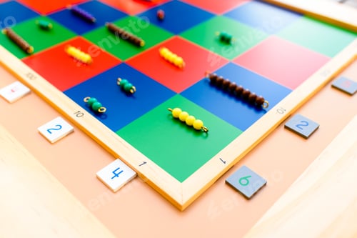 Preview: Detail of montessori material, a checker board with tiles and beads.