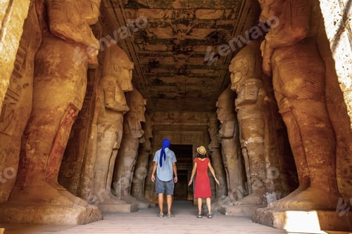 Preview: A tourist couple at the Abu Simbel Temple next to the sculptures, in southern Egypt
