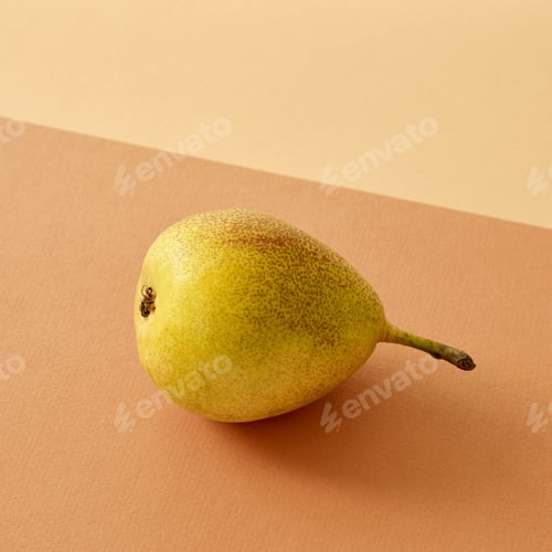 Preview: fresh pear on colored paper background