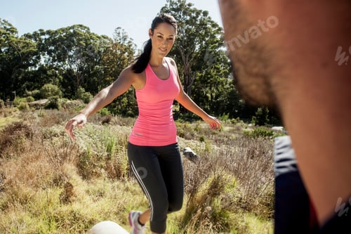 Preview: Man looking at female jogger balancing