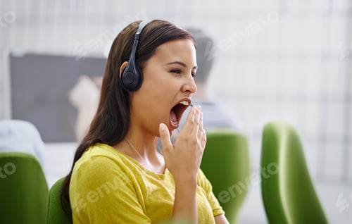 Preview: I think I need a coffee break. Shot of an attractive young female yawning at work.