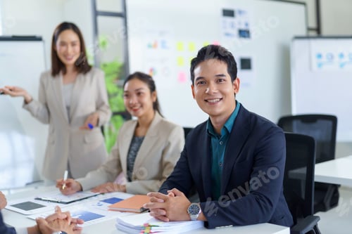 Preview: Asian businesspeople discussing and working together during a meeting in a modern office