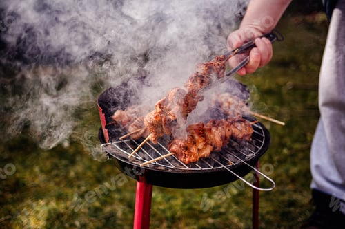Preview: Grilling Meat Skewers Over Hot Charcoal at Outdoor BBQ