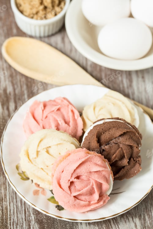 Preview: Plate Of Chocolate Vanilla And Strawberry Cookies With Eggs And Wood Spoon