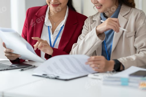 Preview: Two Asian businesswomen discuss working on a new project idea presentation. Calculate marketing plan