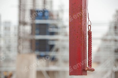 Preview: Selective focus of a hanging rail with a hammer for ringing lunch break or the end of the working