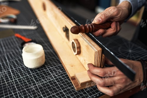 Preview: leather craftsmen working making measupenets in patterns at table in workshop studio