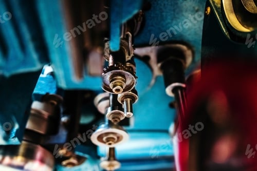 Preview: Detail of the metal elements of a machine, with steel rollers.
