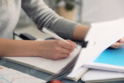 Preview: Office employee working with documents at table, closeup