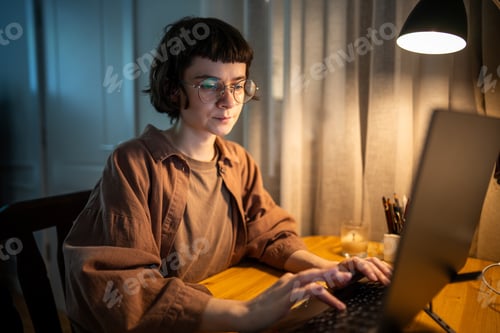 Preview: Stressed exhausted woman working late. Tired female typing on laptop night hours in stress at home