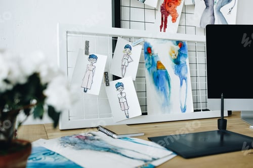 Preview: fashion sketches and digital devices in clothing design studio