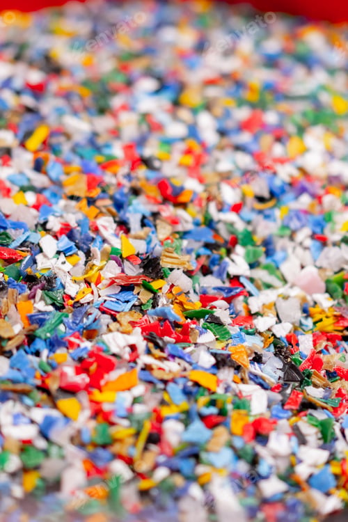 Preview: Close-up shot of shredded plastic caps stored in a special container at waste recycling station