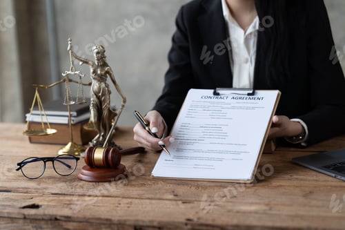 Preview: Businesswoman in suit or lawyer working on a documents.