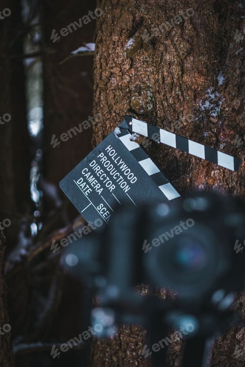 Preview: Movie slate board clapper seen through a blurred digital camera