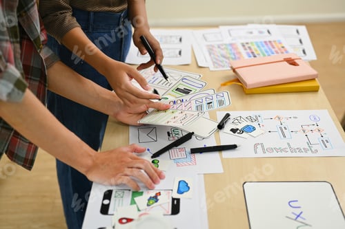 Preview: Group of young creative people working on new website wireframe at office.