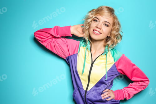 Preview: Stylish young woman posing on color background