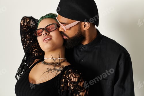 Preview: Stylish multicultural couple enjoying a moment in sunglasses in a chic studio setting