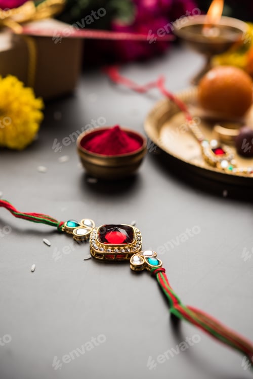 Preview: Indian festival Raksha Bandhan with rakhi bracelets, presents, rice and kumkum and sweets in plate