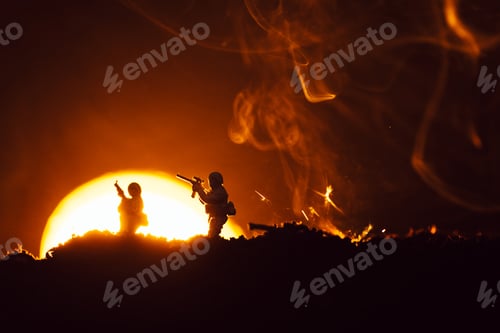 Preview: Battle scene with toy soldiers on battleground with smoke and sunset at background