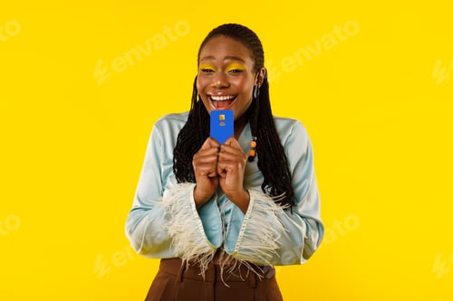 Preview: Excited Black Lady Holding Credit Card Posing Over Yellow Background