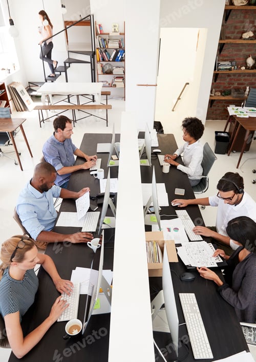 Preview: Colleagues working at a busy open plan office, vertical