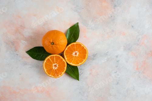 Preview: Whole and half cut clementine mandarins over colorful background