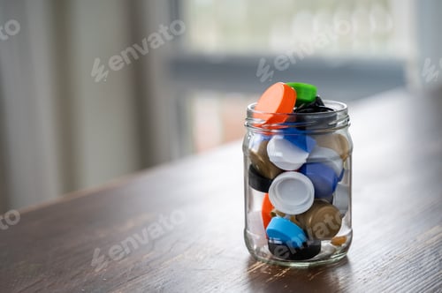 Preview: Glass jar filled with colorful plastic bottle caps