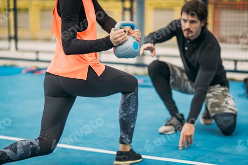 Preview: Personal Trainer with Female Client, Kettlebell Exercise, Outdoors