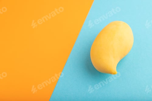 Preview: Orange mango on orange and blue paper pastel, Side view, copy space