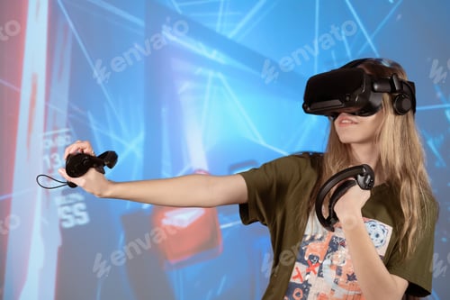 Preview: Young girl in 3D virtual reality glasses. VR glasses and helmet. Futuristic and modern