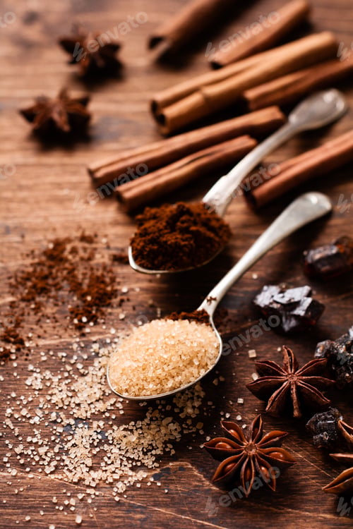 Preview: Assorted natural cinnamon, cane brown sugar, ground coffee, anise stars baking ingredients on a rust