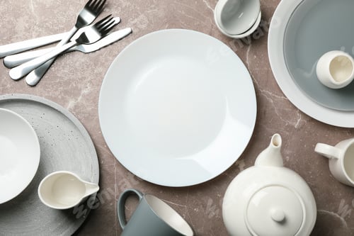 Preview: Tableware and cutlery on grey background, top view and space for text