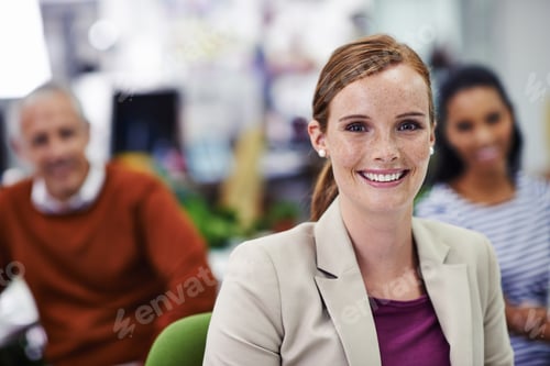 Preview: Portrait of a beautiful young woman with her coworkers in the background