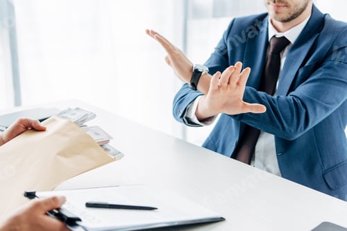 Preview: cropped view of businessman gesturing near business partner giving envelope with money and clipboard