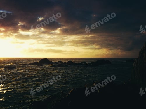 Preview: Sunset in the coastline. Storm clouds. Scenery. Yellow sky.