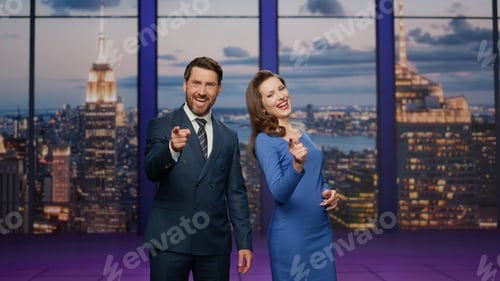 Preview: Two newscasters smiling broadcasting news at television channel. Smiling anchors