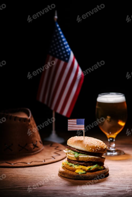 Preview: delicious burger on wooden table with american cowboy hat, usa flag and glass of beer