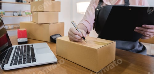 Preview: Business From Home Asian woman preparing package delivery box Shipping for shopping online. young