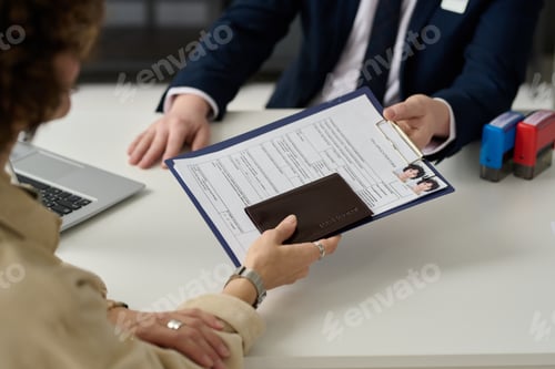 Preview: Close up of woman holding visa application form